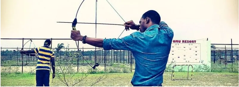 Nigerian archers drawing their bows at a practice range
