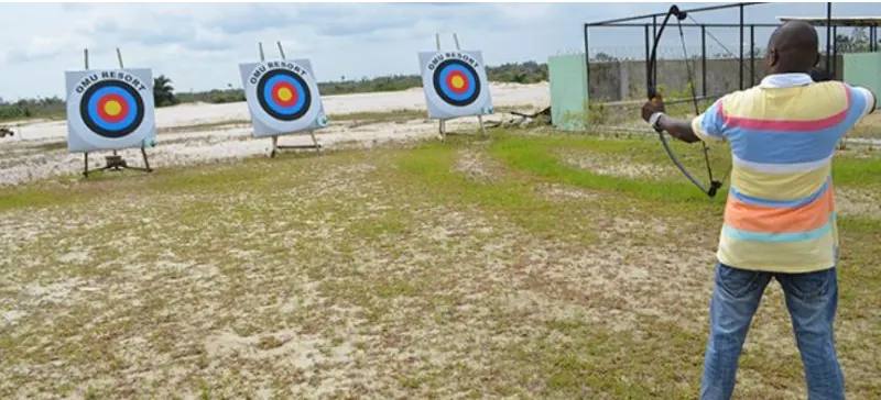An archer aiming at targets on an outdoor range