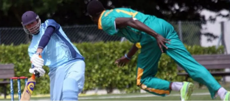 A Nigerian fielder diving in a match against a visiting team