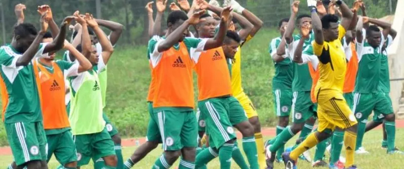 Young Nigerian players dancing in celebration on the pitch