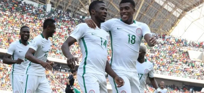Nigerian players celebrating in a packed stadium