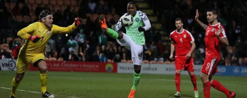 A Nigerian forward shooting in an international match