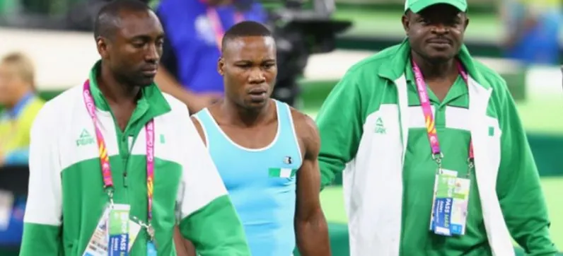 A Nigerian male gymnast with team officials at the Commonwealth Games