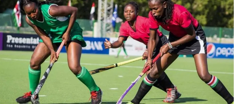 A Nigerian player in green battling for the ball