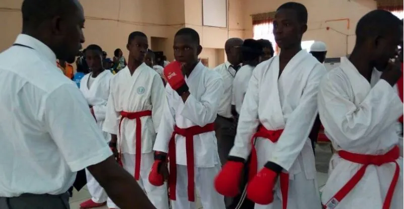 A referee briefing Nigerian karatekas before a bout