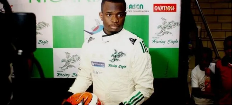 A Nigerian racing driver in a green-and-white race suit