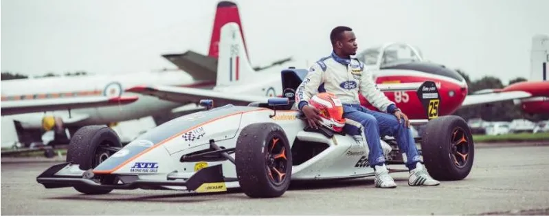 A Nigerian driver seated on a single-seater racing car