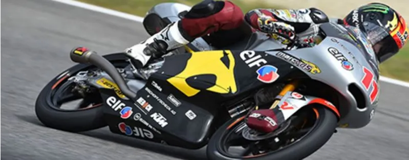 A motorcycle racer leaning into a corner