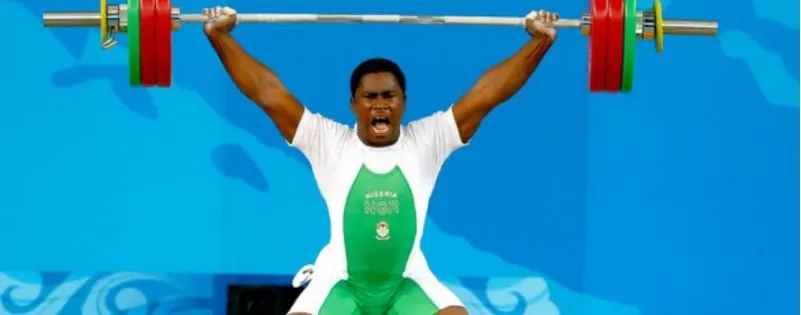 A Nigerian weightlifter lifting the bar overhead