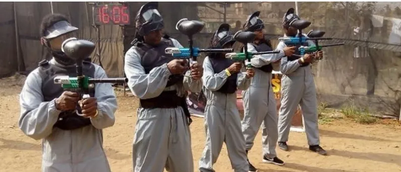 Players in grey overalls aiming their markers