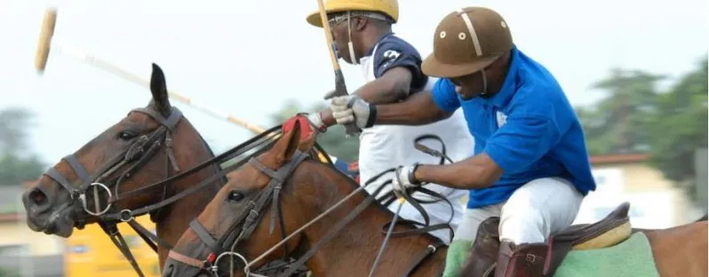 Two polo players riding off at a Nigerian club