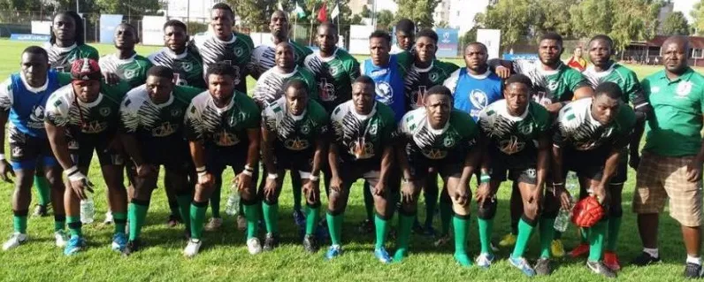 A Nigerian rugby squad in green and white kit lined up with coaches and officials