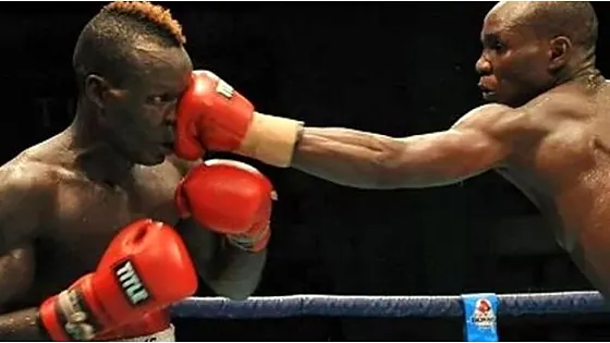 Two boxers exchanging punches in the ring