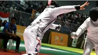 Two fencers lunging during a bout