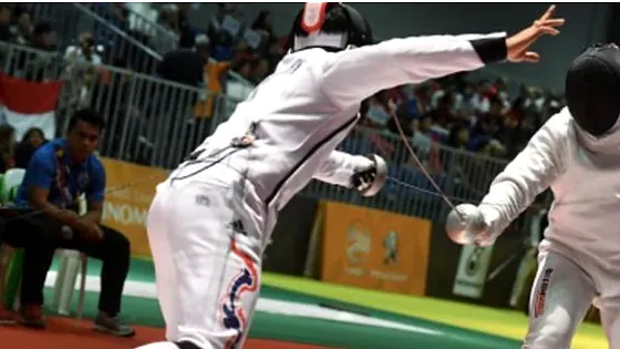 Two fencers lunging during a bout