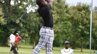 Nigerian golfer finishing a swing
