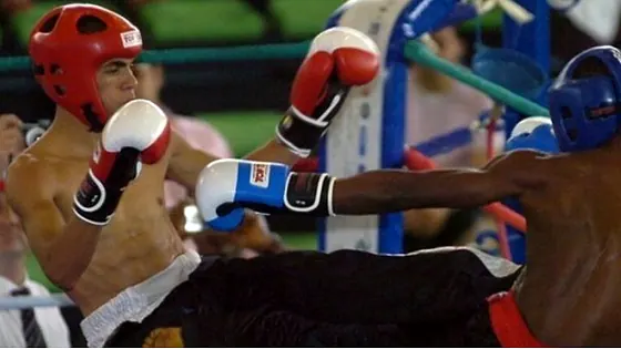 Kickboxer landing a kick in the ring