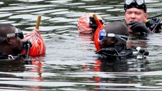 Scuba divers surfacing in open water