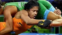 Nigerian wrestler taking down an opponent
