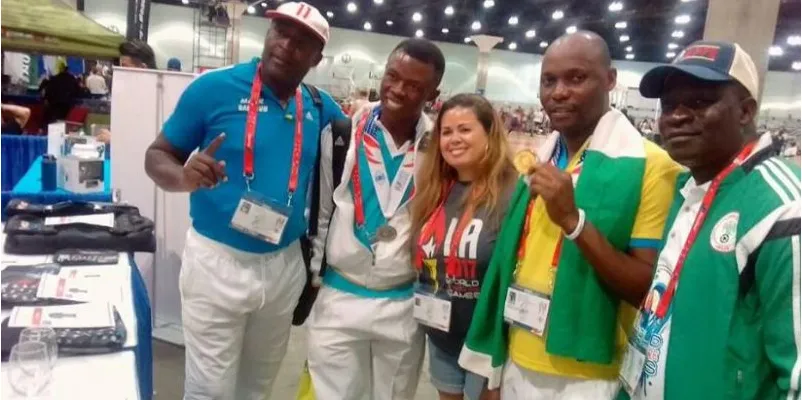 Nigerian officials and a medal-winning swimmer at an international championship
