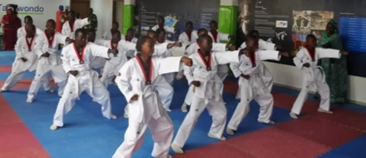 Young Nigerian taekwondo students training in a hall