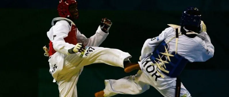 Two fighters exchanging kicks