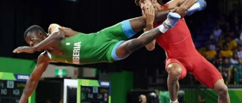 A Nigerian wrestler diving for a takedown