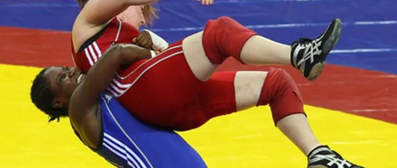 Two wrestlers in a scramble on the mat