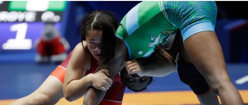 A Nigerian wrestler lifting her opponent
